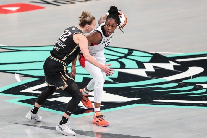 Las Vegas Aces guard Chelsea Gray dribbles past New York Liberty guard Courtney Vandersloot.